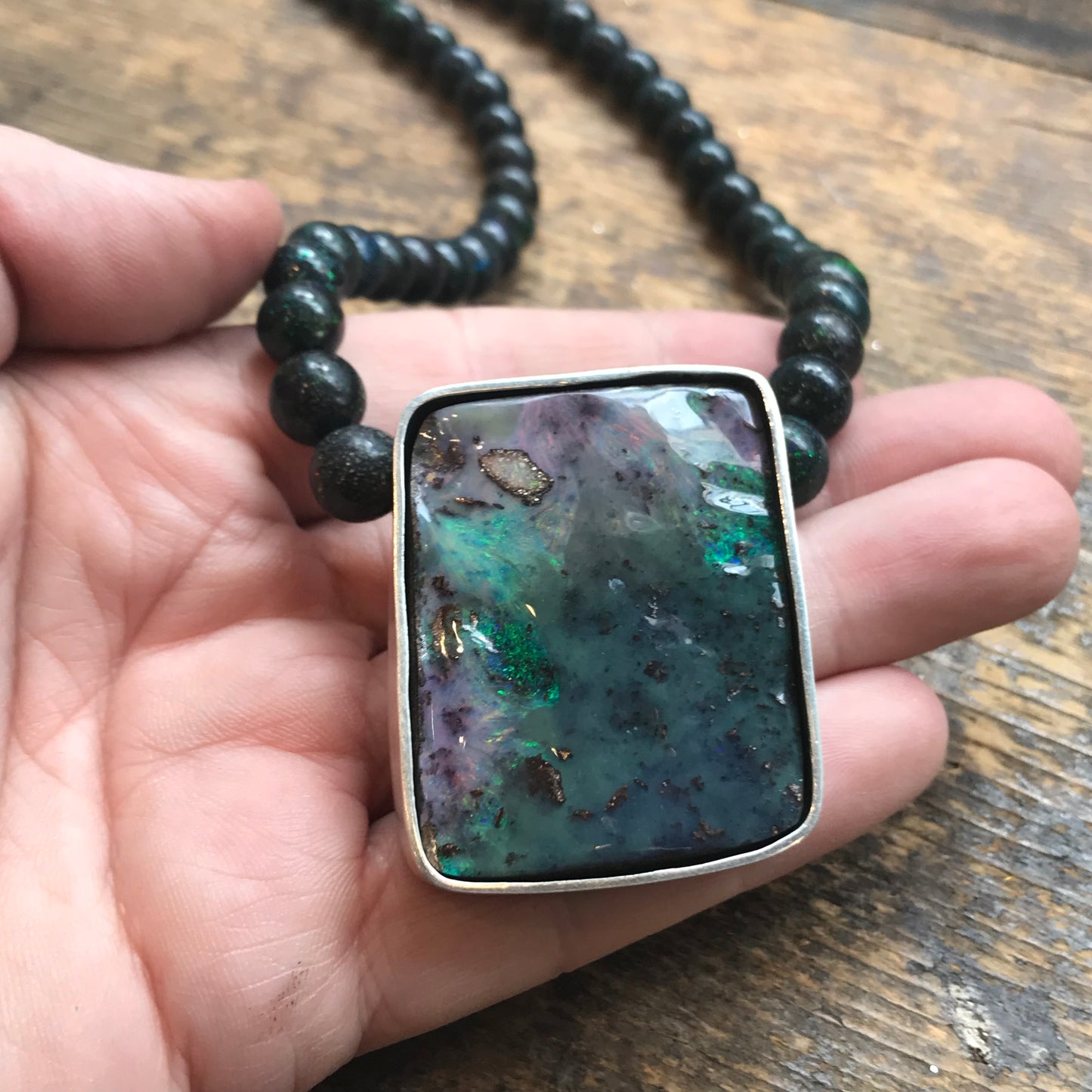 Australian boulder opal silver pendant on opal beads.