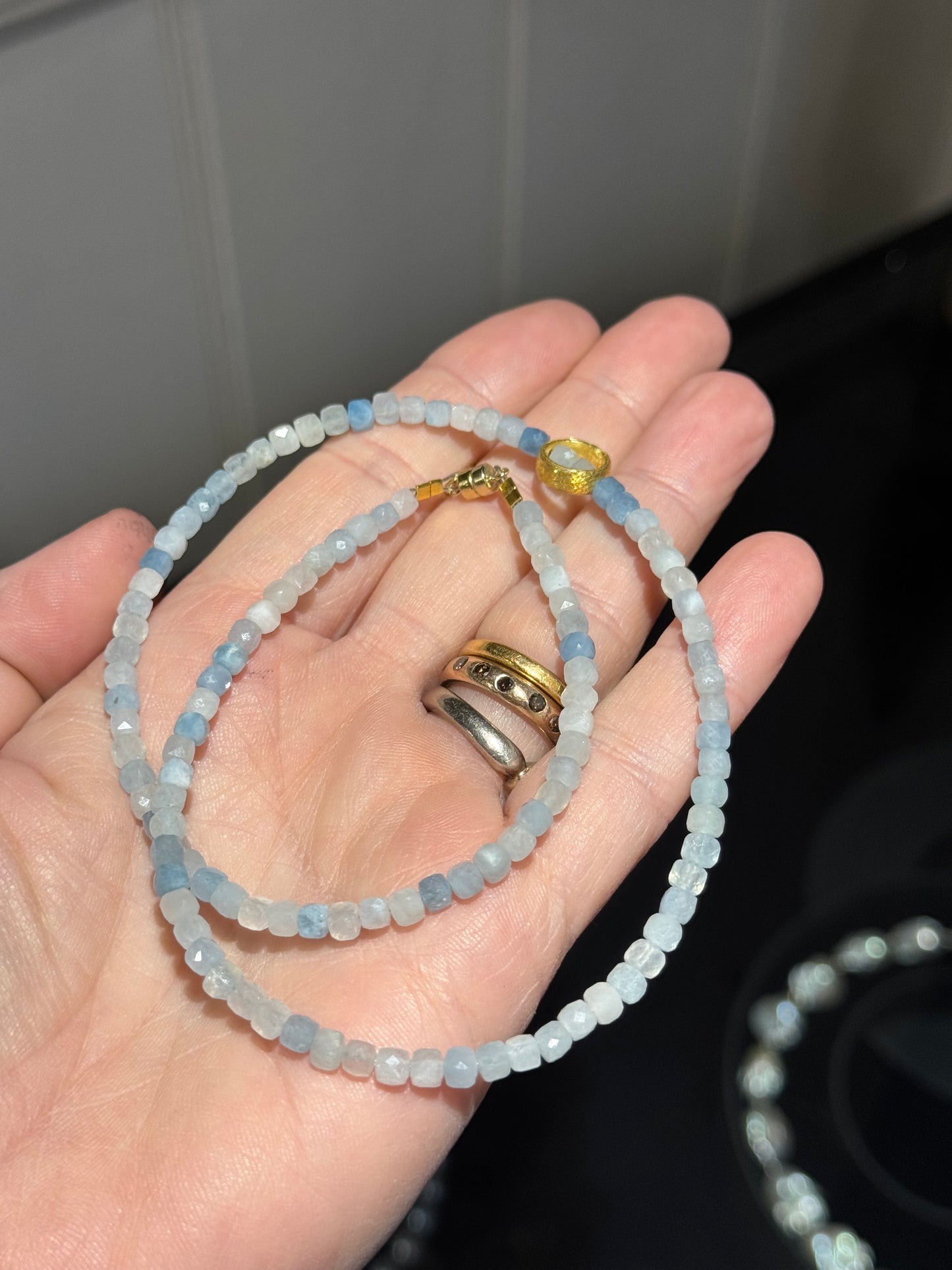 Aquamarine faceted cube silver-gilt ring necklace.